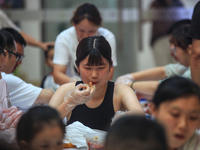 Citizens are taking part in an activity to ''eat shrimp'' at a commercial center in Huai'an city, Jiangsu province, China, on July 21, 2024....