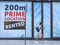 People are seen walking by a closed storefront in Lisbon, Portugal, on July 21, 2024. An interruption of Microsoft systems, related to the c...