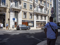 People are walking by the Louis Vuitton storefront building in Lisbon, Portugal, on July 21, 2024. An interruption of Microsoft systems, rel...