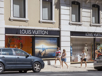 People are walking by the Louis Vuitton storefront building in Lisbon, Portugal, on July 21, 2024. An interruption of Microsoft systems, rel...