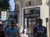 People are walking by the Louis Vuitton storefront building in Lisbon, Portugal, on July 21, 2024. An interruption of Microsoft systems, rel...