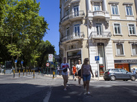 People are walking by the Louis Vuitton storefront building in Lisbon, Portugal, on July 21, 2024. An interruption of Microsoft systems, rel...