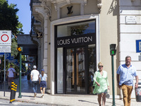 People are walking by the Louis Vuitton storefront building in Lisbon, Portugal, on July 21, 2024. An interruption of Microsoft systems, rel...