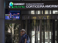 People are walking by the Lisbon Stock Exchange building in Lisbon, Portugal, on July 21, 2024. An interruption of Microsoft systems, relate...