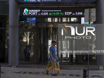 People are walking by the Lisbon Stock Exchange building in Lisbon, Portugal, on July 21, 2024. An interruption of Microsoft systems, relate...