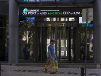 People are walking by the Lisbon Stock Exchange building in Lisbon, Portugal, on July 21, 2024. An interruption of Microsoft systems, relate...