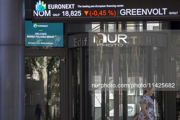 A person is walking by the Lisbon Stock Exchange building in Lisbon, Portugal, on July 21, 2024. An interruption of Microsoft systems, relat...