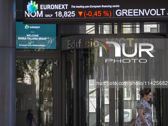 A person is walking by the Lisbon Stock Exchange building in Lisbon, Portugal, on July 21, 2024. An interruption of Microsoft systems, relat...