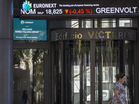 A person is walking by the Lisbon Stock Exchange building in Lisbon, Portugal, on July 21, 2024. An interruption of Microsoft systems, relat...