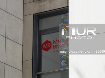 A Crypto store logo is being seen on a building in Lisbon, Portugal, on July 21, 2024. An interruption of Microsoft systems, related to the...