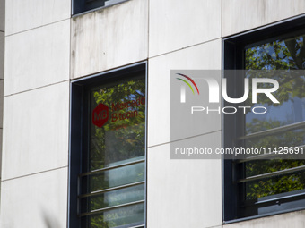 A Crypto store logo is being seen on a building in Lisbon, Portugal, on July 21, 2024. An interruption of Microsoft systems, related to the...