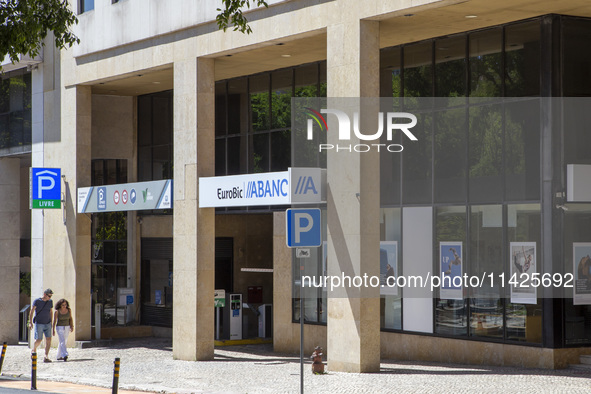 People are walking by an Abanca location in Lisbon, Portugal, on July 21, 2024. An interruption of Microsoft systems, related to the cyberse...