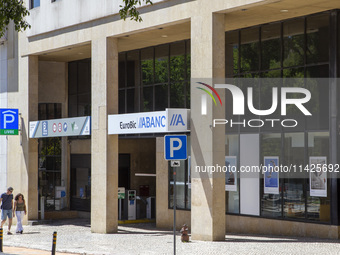 People are walking by an Abanca location in Lisbon, Portugal, on July 21, 2024. An interruption of Microsoft systems, related to the cyberse...