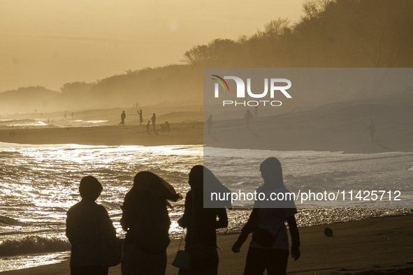 People are visiting Goa Cemara Beach, one of the tourist destinations in Bantul, Yogyakarta, Indonesia, during sunset on July 21, 2024. 