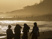 People are visiting Goa Cemara Beach, one of the tourist destinations in Bantul, Yogyakarta, Indonesia, during sunset on July 21, 2024. (