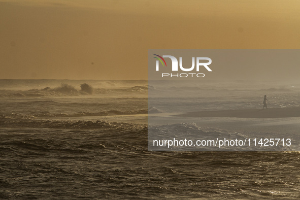 A woman is visiting Goa Cemara Beach, one of the tourist destinations in Bantul, Yogyakarta, Indonesia, on July 21, 2024, during sunset. 