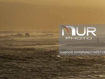 A woman is visiting Goa Cemara Beach, one of the tourist destinations in Bantul, Yogyakarta, Indonesia, on July 21, 2024, during sunset. (