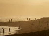 People are visiting Goa Cemara Beach, one of the tourist destinations in Bantul, Yogyakarta, Indonesia, during sunset on July 21, 2024. (