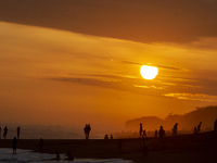 People are visiting Goa Cemara Beach, one of the tourist destinations in Bantul, Yogyakarta, Indonesia, during sunset on July 21, 2024. (