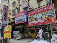 People are passing next to an International Bus transport office in Kolkata, India, on July 21, 2024. International Bus Service is stopping...