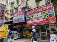 People are passing next to an International Bus transport office in Kolkata, India, on July 21, 2024. International Bus Service is stopping...