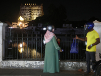 People are standing near the historic Sree Padmanabhaswamy Temple during the night of the Vishu Festival in Thiruvananthapuram (Trivandrum),...