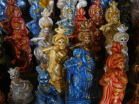 Clay idols of Lord Krishna are being sold along the roadside just outside the historic Sree Padmanabhaswamy Temple during the night of the V...