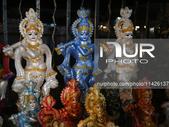 Clay idols of Lord Krishna are being sold along the roadside just outside the historic Sree Padmanabhaswamy Temple during the night of the V...