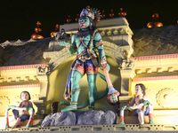 The statue of Hanuman atop the Sree Hanuman Swamy Temple is being seen during the night of the Vishu Festival in Thiruvananthapuram (Trivand...