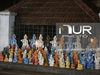 Clay idols of Lord Krishna are being sold along the roadside just outside the historic Sree Padmanabhaswamy Temple during the night of the V...