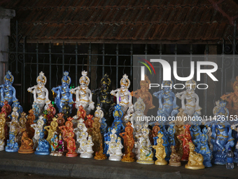 Clay idols of Lord Krishna are being sold along the roadside just outside the historic Sree Padmanabhaswamy Temple during the night of the V...