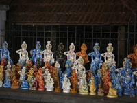 Clay idols of Lord Krishna are being sold along the roadside just outside the historic Sree Padmanabhaswamy Temple during the night of the V...