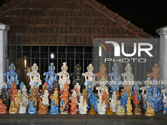 Clay idols of Lord Krishna are being sold along the roadside just outside the historic Sree Padmanabhaswamy Temple during the night of the V...