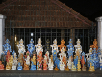 Clay idols of Lord Krishna are being sold along the roadside just outside the historic Sree Padmanabhaswamy Temple during the night of the V...