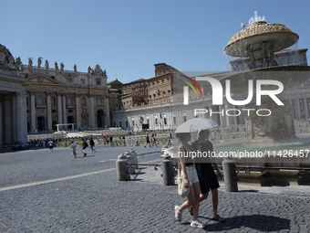 Tourists are filling up water bottles from a public fountain in Saint Peter, Rome, Italy, on July 21, 2024. (