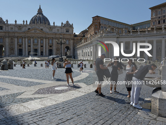 Tourists are filling up water bottles from a public fountain in Saint Peter, Rome, Italy, on July 21, 2024. (