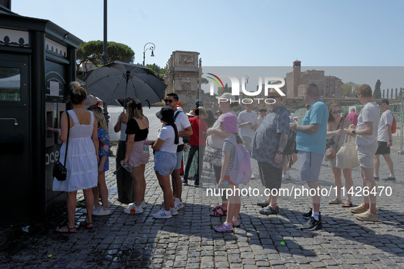 Tourists are queuing to get water from a free water dispenser in front of the Colosseum in Rome, Italy, on July 21, 2024. 