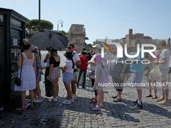 Tourists are queuing to get water from a free water dispenser in front of the Colosseum in Rome, Italy, on July 21, 2024. (