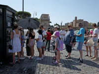 Tourists are queuing to get water from a free water dispenser in front of the Colosseum in Rome, Italy, on July 21, 2024. (