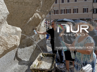 Tourists are trying to cool off with the help of fountains in the streets in Rome, Italy, on July 21, 2024, as the city is on alert for extr...