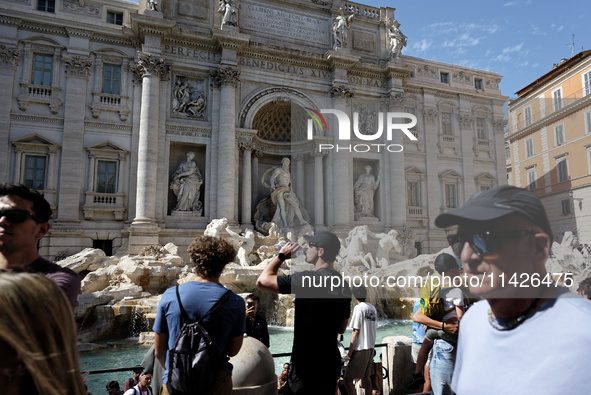 Tourists are trying to cool off with the help of fountains in the streets in Rome, Italy, on July 21, 2024, as the city is on alert for extr...