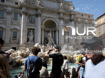 Tourists are trying to cool off with the help of fountains in the streets in Rome, Italy, on July 21, 2024, as the city is on alert for extr...