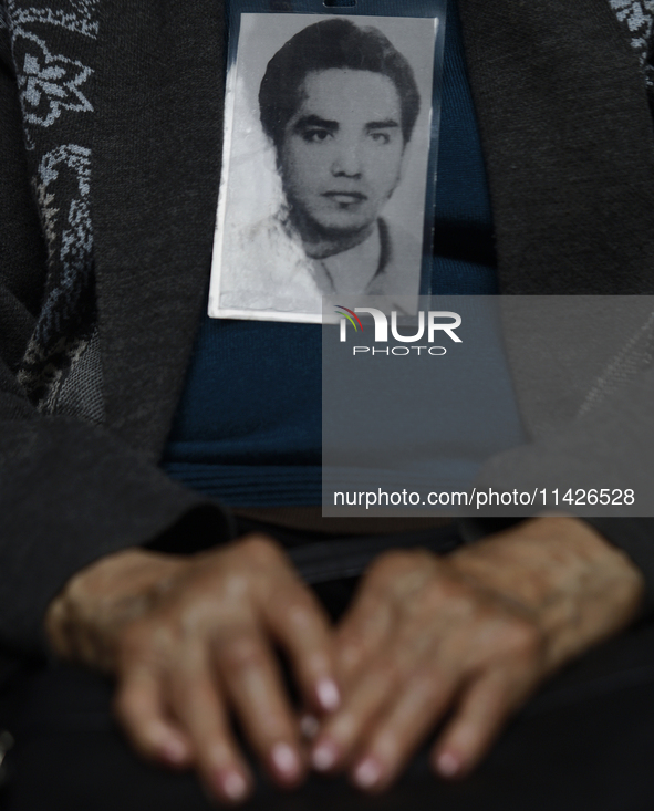 A photograph belonging to a victim of enforced disappearance in Mexico is being viewed. 