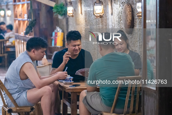 Residents are drinking tea at an old teahouse in a bomb shelter as the high temperature continues in Chongqing, China, on July 21, 2024. 