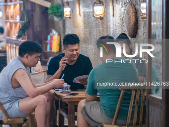 Residents are drinking tea at an old teahouse in a bomb shelter as the high temperature continues in Chongqing, China, on July 21, 2024. (