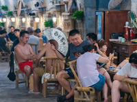 Residents are drinking tea at an old teahouse in a bomb shelter as the high temperature continues in Chongqing, China, on July 21, 2024. (