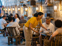 Residents are drinking tea at an old teahouse in a bomb shelter as the high temperature continues in Chongqing, China, on July 21, 2024. (