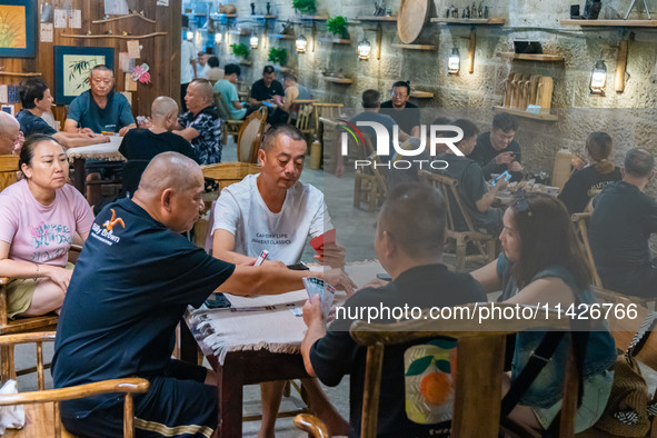 Residents are drinking tea at an old teahouse in a bomb shelter as the high temperature continues in Chongqing, China, on July 21, 2024. 