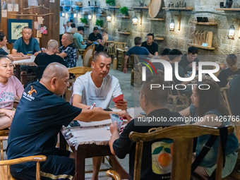 Residents are drinking tea at an old teahouse in a bomb shelter as the high temperature continues in Chongqing, China, on July 21, 2024. (