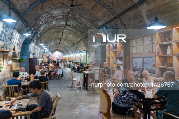 Residents are drinking tea at an old teahouse in a bomb shelter as the high temperature continues in Chongqing, China, on July 21, 2024. 